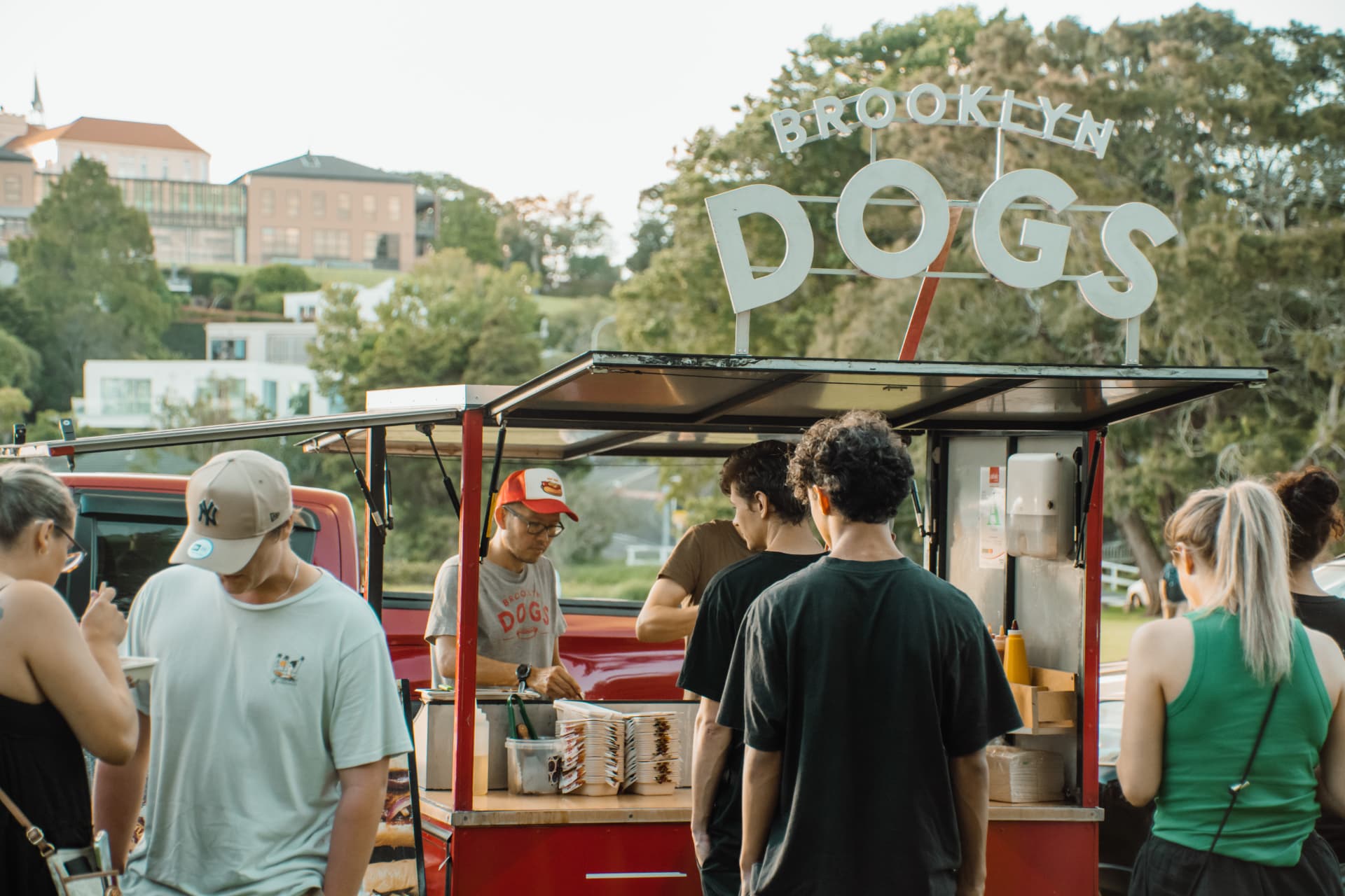 Crowd queuing at the Brooklyn Dogs truck in the park