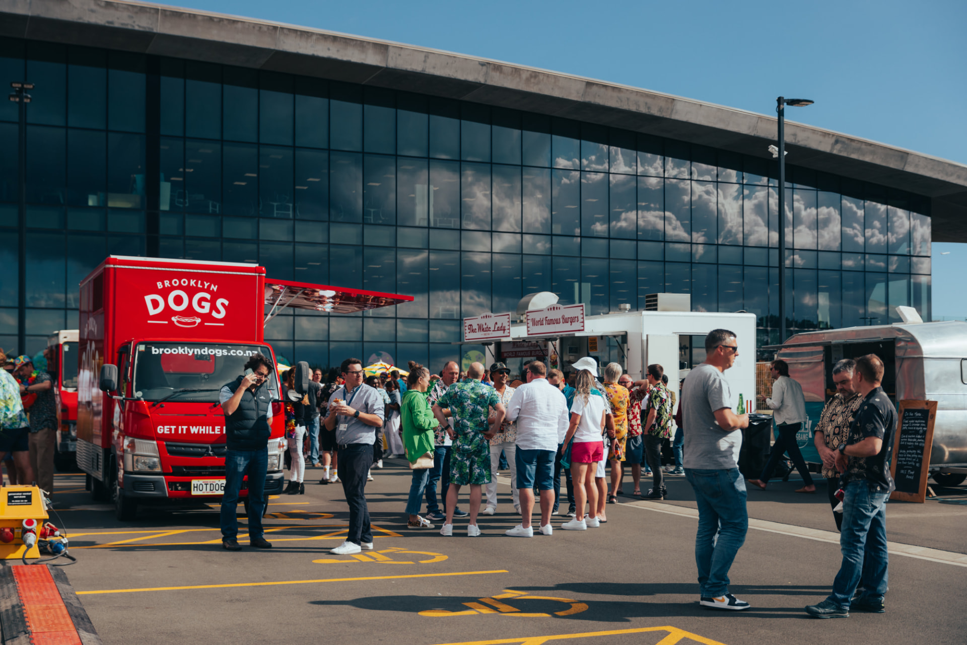The Brooklyn Dogs red food truck with its awning open at an event