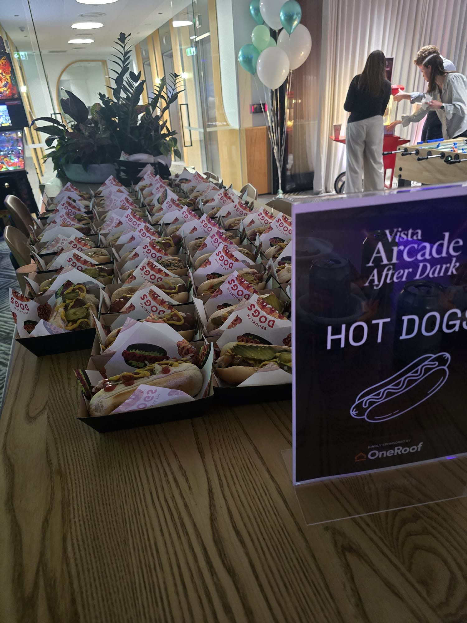 Rows of Brooklyn Dogs hot dog boxes laid out at an office function