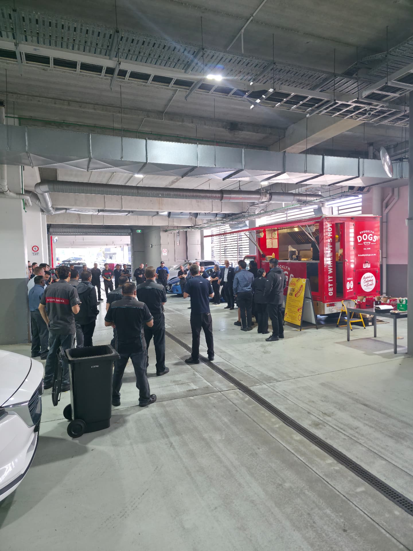 The Brooklyn Dogs truck serving a service team in a workshop