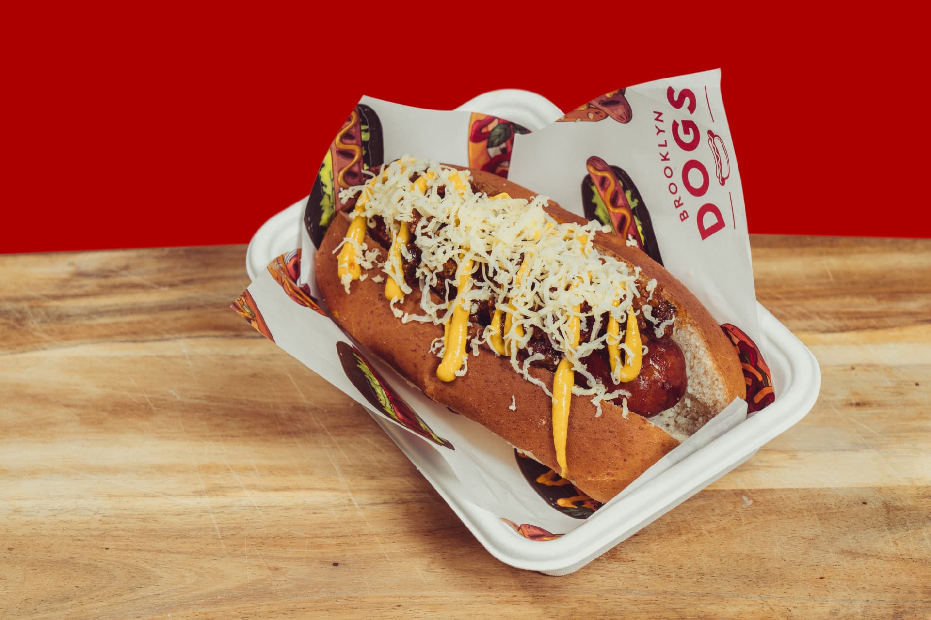 Brooklyn Dogs hot dog covered in cheese sauce and grated cheese